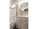 Bright bathroom featuring a shower and bathtub combination with clear sliding door and white vanity at 1320 N New Jersey St, Indianapolis, IN 46202