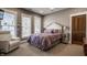 A bedroom featuring soft carpet, a plush duvet cover on the bed, and two windows with wooden shutters at 1320 N New Jersey St, Indianapolis, IN 46202