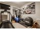 This is an exercise room with equipment, weights, a television, and an eclectic decor at 1320 N New Jersey St, Indianapolis, IN 46202
