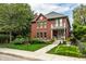 Charming two-story brick home with landscaped front yard and inviting porch swing at 1320 N New Jersey St, Indianapolis, IN 46202