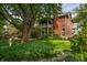 Charming brick home with a covered porch and lush green lawn, complete with a statue at 1320 N New Jersey St, Indianapolis, IN 46202