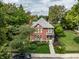 Stately brick home with a manicured lawn and charming front porch at 1320 N New Jersey St, Indianapolis, IN 46202