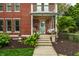 Welcoming front porch with a swing, potted flowers, and a view of the front entrance at 1320 N New Jersey St, Indianapolis, IN 46202