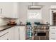 Gourmet kitchen showcasing stainless steel range, granite countertops, and custom cabinetry at 1320 N New Jersey St, Indianapolis, IN 46202