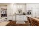 Bright kitchen with custom white cabinets, built-in bar and stainless steel appliances at 1320 N New Jersey St, Indianapolis, IN 46202