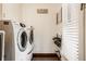 Efficient laundry room with side-by-side appliances, storage, and folding rack near a bright window at 1320 N New Jersey St, Indianapolis, IN 46202