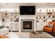 Spacious living room featuring a cozy fireplace, custom built-ins, and a large screen TV at 1320 N New Jersey St, Indianapolis, IN 46202