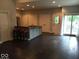 Open-concept living room with hardwood floors, breakfast bar and access to outdoor patio at 1320 N New Jersey St, Indianapolis, IN 46202