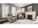 Inviting living room with a cozy fireplace, comfortable chairs, and bright windows creates a relaxing space at 1320 N New Jersey St, Indianapolis, IN 46202
