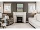 Bright living room with a charming fireplace, elegant furnishings, and ample natural light at 1320 N New Jersey St, Indianapolis, IN 46202