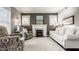 Cozy living room with a classic fireplace, plush seating, and bright windows for a relaxing ambiance at 1320 N New Jersey St, Indianapolis, IN 46202