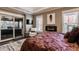 Comfortable main bedroom featuring hardwood floors, a fireplace, and sliding doors to the outdoor patio at 1320 N New Jersey St, Indianapolis, IN 46202