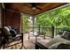 Covered porch with brick surround, tongue-and-groove ceiling, furniture, and tree views at 1320 N New Jersey St, Indianapolis, IN 46202