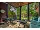 Inviting screened-in porch with comfortable seating, a ceiling fan, and serene views of the lush backyard at 1320 N New Jersey St, Indianapolis, IN 46202