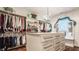 Well-organized walk-in closet with custom shelving, drawers, and a chandelier at 1320 N New Jersey St, Indianapolis, IN 46202