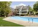 Beautiful backyard with in-ground pool, lounge chairs, dining area, and manicured lawn at 13661 Smokey Ridge Pl, Carmel, IN 46033