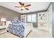 This bedroom includes a ceiling fan, built-in shelving, and a window at 13661 Smokey Ridge Pl, Carmel, IN 46033