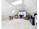 Finished attic space with neutral paint, two sitting chairs, and an office space at 13661 Smokey Ridge Pl, Carmel, IN 46033