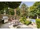 Outdoor deck with a grill, dining area, and lush greenery, perfect for outdoor entertaining at 13661 Smokey Ridge Pl, Carmel, IN 46033