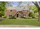Charming two-story brick home with well-manicured lawn and mature landscaping at 13661 Smokey Ridge Pl, Carmel, IN 46033