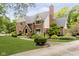 Beautiful brick home featuring a lush green lawn, mature trees, and a well-manicured landscape at 13661 Smokey Ridge Pl, Carmel, IN 46033