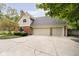 Spacious three-car garage with a paved driveway, offering ample parking and storage at 13661 Smokey Ridge Pl, Carmel, IN 46033
