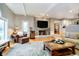 Cozy living room featuring a stone fireplace, hardwood floors, built-in shelving, and plush seating at 13661 Smokey Ridge Pl, Carmel, IN 46033
