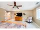 This main bedroom has a ceiling fan and a lovely chair beside the window at 13661 Smokey Ridge Pl, Carmel, IN 46033