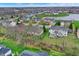 Overhead view of a residential area with a pond and an assortment of well-maintained homes and green spaces at 14242 Brandt Ln, Carmel, IN 46074