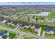 Wide aerial shot of a planned community featuring manicured lawns, tree-lined streets, and varied home designs at 14242 Brandt Ln, Carmel, IN 46074
