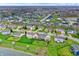 Neighborhood aerial view showcasing manicured lawns, varied architecture, and a serene community pond at 14242 Brandt Ln, Carmel, IN 46074