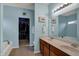 Light blue bathroom with double vanity, large mirror, soaking tub and a walk-in closet at 14242 Brandt Ln, Carmel, IN 46074