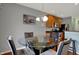 Dining area featuring a glass table and seating, adjacent to kitchen cabinets at 14242 Brandt Ln, Carmel, IN 46074