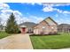 Attractive brick home with a well-maintained lawn and a striking red front door, creating curb appeal at 14242 Brandt Ln, Carmel, IN 46074