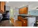 Kitchen with brown cabinets and black appliances, flowing into an open floor plan at 14242 Brandt Ln, Carmel, IN 46074