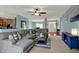 Open living room featuring sectional sofa, ceiling fan, neutral paint, and great natural light at 14242 Brandt Ln, Carmel, IN 46074