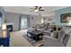Spacious living room featuring fireplace, plush sectional sofa, ceiling fan, and lots of natural light at 14242 Brandt Ln, Carmel, IN 46074