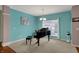 Cozy living room with piano, neutral carpet, large window, soft paint colors, and natural light at 14242 Brandt Ln, Carmel, IN 46074