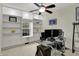 Bright home office with built-in shelving and a glass desk illuminated by natural light at 14242 Brandt Ln, Carmel, IN 46074
