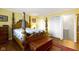 Traditional bedroom featuring yellow walls and an ornate, four-poster bed with an adjoined bathroom with updated cabinets at 15247 E 191St St, Noblesville, IN 46060