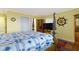 Bedroom featuring yellow walls, hardwood floors, four-poster bed, and built-in display case at 15247 E 191St St, Noblesville, IN 46060