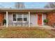 Inviting front porch with chairs and a vibrant red door offers a welcoming entrance at 15247 E 191St St, Noblesville, IN 46060