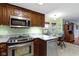 Updated kitchen boasts granite countertops, stainless steel appliances, and a modern stove at 15247 E 191St St, Noblesville, IN 46060