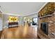 Bright living room with hardwood floors, decorative fireplace, and seamless flow to other living spaces at 15247 E 191St St, Noblesville, IN 46060
