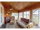 Cozy sunroom with wood ceiling, lots of natural light, and comfortable seating with a beautiful view of the outdoors at 15247 E 191St St, Noblesville, IN 46060