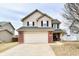 Charming two-story home featuring a two-car garage, brick accents, and neutral siding under a cloudy sky at 15281 Proud Truth Dr, Noblesville, IN 46060