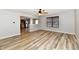 Bright, airy living room with neutral paint, wood-style flooring, and a view into the kitchen area at 15281 Proud Truth Dr, Noblesville, IN 46060