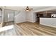 Bright, spacious living area featuring wood-style flooring and a view to the kitchen and stairway at 15281 Proud Truth Dr, Noblesville, IN 46060