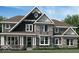 Beautiful new construction home featuring stone accents, a covered porch, and a meticulously landscaped yard at 1560 Old Hickory Ln, Westfield, IN 46074