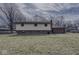 Back view of house with a large lawn leading to the back entrance of a two story brick house at 1612 Westbay Ct, Indianapolis, IN 46260